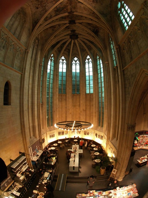 most-interesting-bookstores-of-the-world02 Where the altar used to be in the Dominican church in Maastricht you can now have a coffee and read a book. The church is a bookshop (Selexyz Dominicanen) now. The photo was taken from the second storey of the building they put inside the church with the books. Essentially they built a three floor bookcase inside the church. Photo by wisze and used per a CC Attribution-Noncommercial-No Derivative Works 2.0 Generic License.
